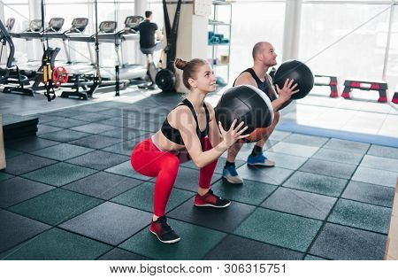 Сouple Functional Training. Sporty Man And Fit Woman Do Exercise With Medicine Ball In Gym