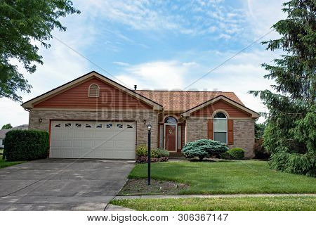Little Stone House with Brown Trim