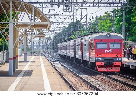 People Got Off The Train. . The Train Has Arrived. People Walk On The Platform. Russia, Leningrad Re
