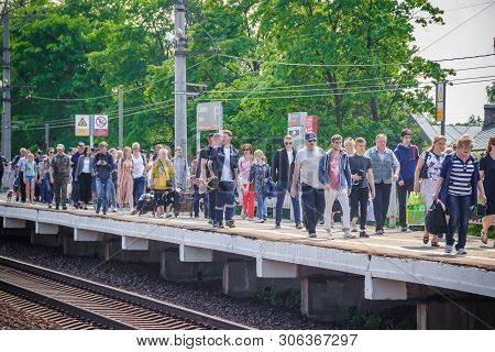 People Got Off The Train. . The Train Has Arrived. People Walk On The Platform. Russia, Leningrad Re