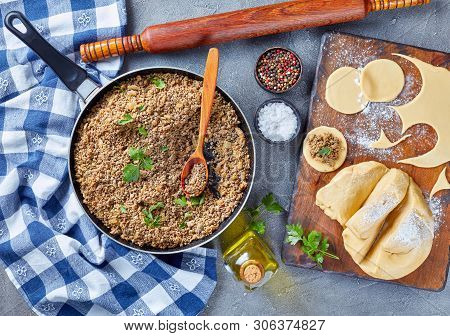 Cooking Pierogies With Ground Liver With Onion Filling Fried In A Skillet, Raw Dough And Uncooked Du