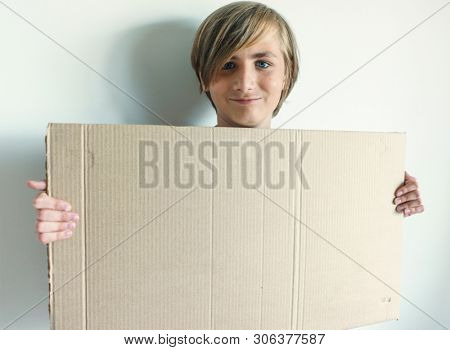 Boy Showing Blank Signboard with Empty Copyspace