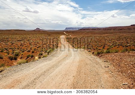 Dirt Road In Red Desert Landscape In The Us
