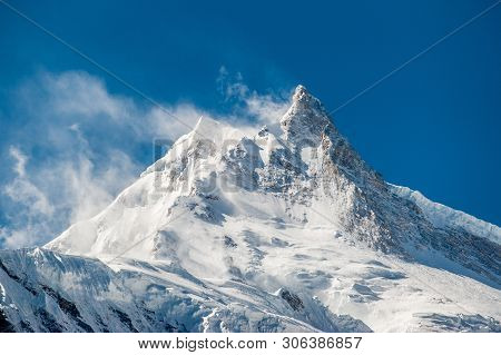 View Of Snow Covered Peak Of Mount Manaslu (8 156 Meters) With Clouds In Himalayas, Sunny Day At Man