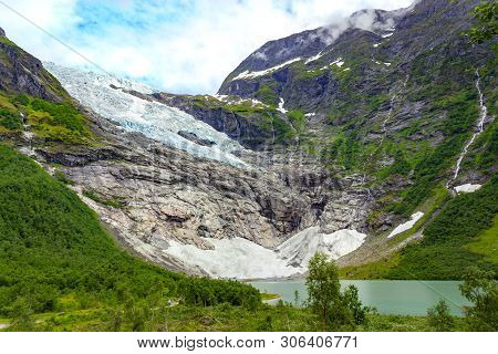 Landscape With River Near Briksdal Or Briksdalsbreen Glacier In Olden, Norway With Green Mountain. N