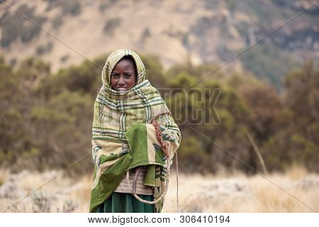 Simien Mountain, Ethiopia, April 25.2019, Little Ethiopian Shepherdess Girl Veiled In A Blanket With