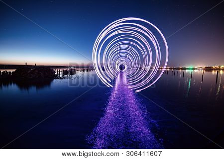 Amazing Laser Fireshow Performance In The Night Blue Sky With Reflections In The Sea Water