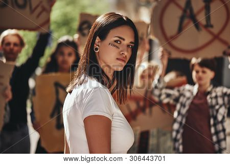 Fighting For My Rights. Young Activist With Word Freedom Written On Her Face Looking At Camera While