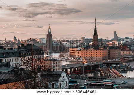 View From Slussen At Sunset Towards Riddarholmen And City Hall As Well As The Bridges, The Landmarks