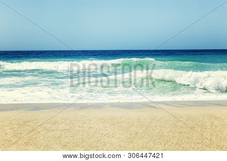 Turquoise Sea With A Sandy Beach. Sunny Weather, Bright Blue Sky. Beautiful Landscape. Space For Tex