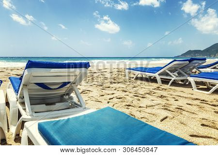 Beach Chairs On A Sandy Beach By The Sea.