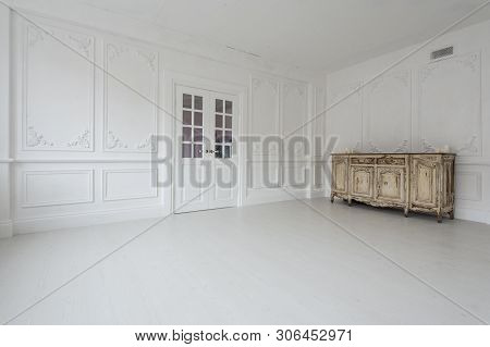 Luxurious Bright Interior With Stucco Walls And Vintage Chest Of Drawers.
