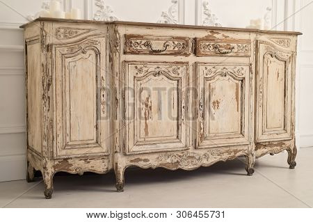 Luxurious Bright Interior With Stucco Walls And Vintage Chest Of Drawers.