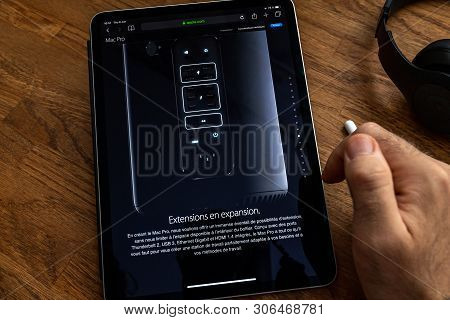 Paris, France - Jun 6, 2019: Man Reading On Apple Ipad Pro Tablet About Powerful Professional Workst