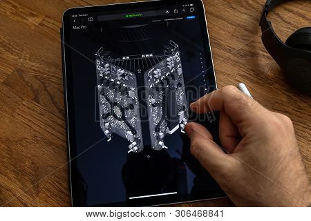 Paris, France - Jun 6, 2019: Man Reading On Apple Ipad Pro Tablet About Powerful Professional Workst