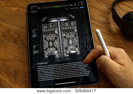 Paris, France - Jun 6, 2019: Man Reading On Apple Ipad Pro Tablet About Powerful Professional Workst