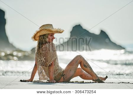 young woman relaxing on the beach in summer day