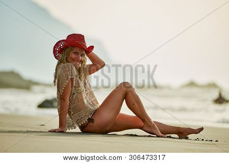 young woman relaxing on the beach in summer day