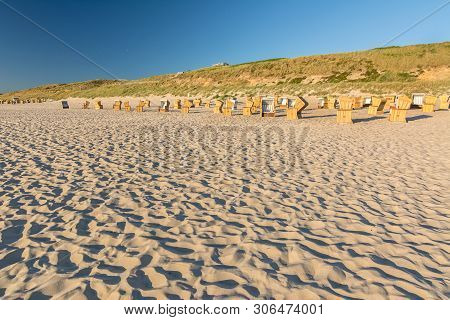 Beach Chairs And Dunes In The Evening Light During A Beautiful Sunset On Sylt