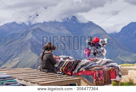 Peruvian Women Selling Colorful Hats And Scarfs On The Scenic And Popular Viewpoint.
