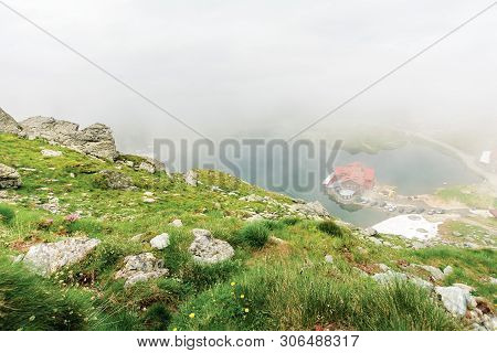 Lake Balea In Dramatic Weather. Beautiful Destination In Fagaras Mountain Of Romania. View Through C