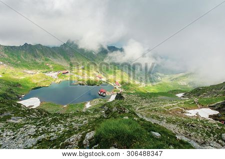 Lake Balea In Dramatic Weather. Beautiful Destination In Fagaras Mountain Of Romania. View Through C