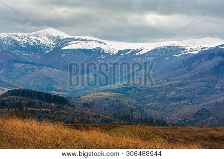 Beautiful Transcarpathian Landscape In November. Overcast Sky Above The Meadow With Weathered Grass 