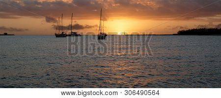 A Picturesque Tropical Stratocumulus Cloudy Nautical Sunrise Seascape Panorama With Moored Yachts At