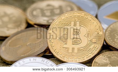Physical Metal Golden Bitcoin Currency Rotating Over Others Coins. Btc