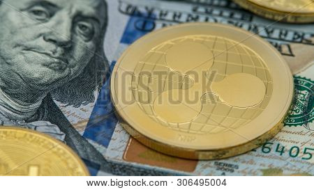 Physical Metal Golden Ripplecoin Currency Over Diferents Dollars Bills