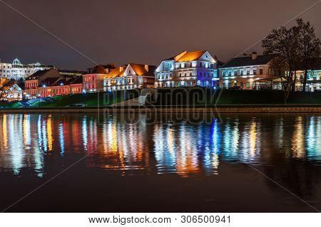 Traetskae Pradmestse Or Trinity Suburb On Svisloch River Bank At Night. Historical Center Of Minsk. 