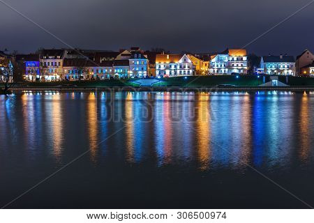 Traetskae Pradmestse Or Trinity Suburb On Svisloch River Bank At Night. Historical Center Of Minsk. 