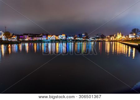 Traetskae Pradmestse Or Trinity Suburb On Svisloch River Bank At Night. Historical Center Of Minsk. 