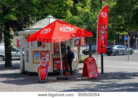 Karlstad, Sweden - June 14, 2019: One Person Stands At The Kiosk Selling The Ice Cream On The Town S