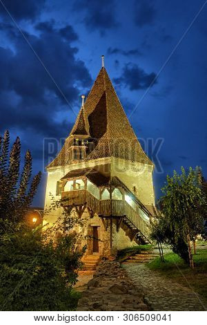 Sighisoara Bootmakers Tower of medieval fortified town at Night, Romania