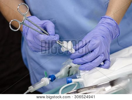 Clean Nurse With Sterile Gauze Stopper Of Bag Of Nutrition Enteral In A Hospital, Conceptual Image