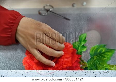 Embroidered Hand With Needle And Silk Thread Over Canvas With Exotic Flowers Close Up