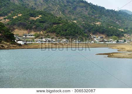 Countryside Landscape, North Korea. Village On Rivershore