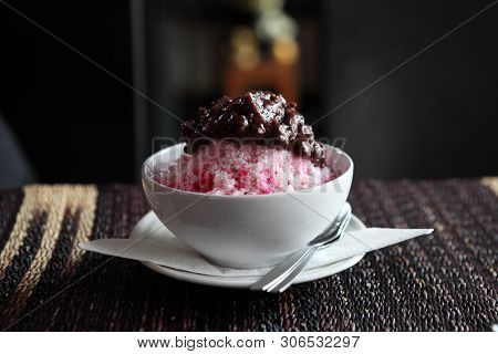 Traditional Japanese Dessert , A Bowl Of Red Bean Sweet With Red Ice On Wood Pattern