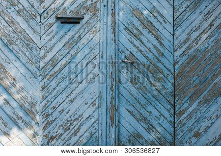 Background Old Wooden Gate With Shabby Blue Paint. Gate With Mail Slot And Door Handle. Texture Of W