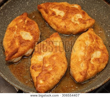 Patties Are Fried In Oil In A Pan .