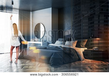 Woman In Gray And Black Bedroom With Mirror