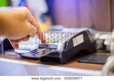 Hand Put Credit Card In Slot And Press The Button Of Credit Card Reader.