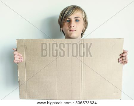Boy Showing Blank Signboard with Empty Copyspace