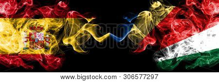 Spain Vs Seychelles, Seychelloise Smoky Mystic Flags Placed Side By Side. Thick Colored Silky Smokes