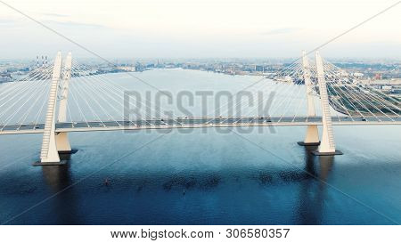Cable-stayed Bridge And Cars Speeding Against Cityscape