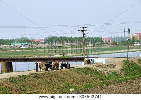 North Korea, Pyongyang - May 4, 2019: Countryside Life, Dprk. Peasant Man In Military Uniform Stands
