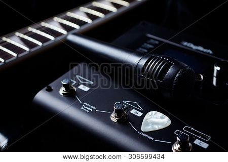 Multieffects Processor For Electric Guitar And A Microphone On Black Background. Close Up.