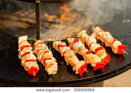 Small Satay Of Meat And Vegetables On Wooden Skewers Fried On A Brazier Close Up