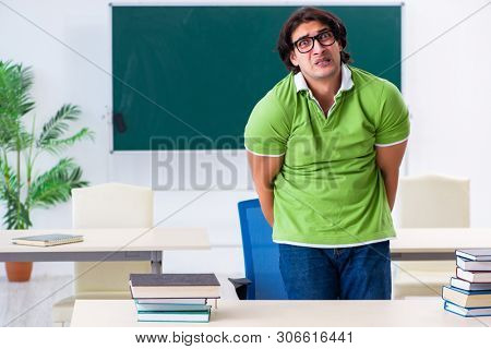 Male student suffering from urge in the classroom  